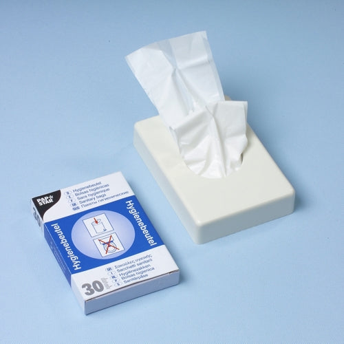 Ein weißer Taschentuchspender steht neben einem Starpak 30 Hygienebeutel Spenderkarton (28,5 x 8 x 7 cm, weiß), der 30 Hygienebeutel mit Anleitungsbildern auf einer hellblauen Oberfläche enthält.