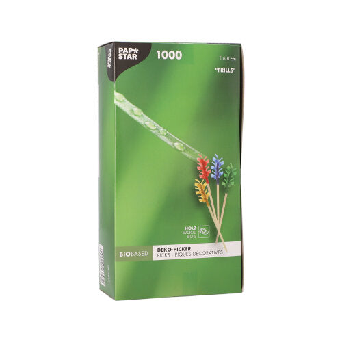 Der PAPSTAR 1000 Deko-Picker 6,8 cm „Rüschen“ der PAPSTAR GmbH wird in einer grünen Box mit bunten Rüschenspießen zur Tischdekoration geliefert und verfügt über eine Verpackung, auf der die Spieße und ein Tautropfen auf Gras in Nahaufnahme abgebildet sind.