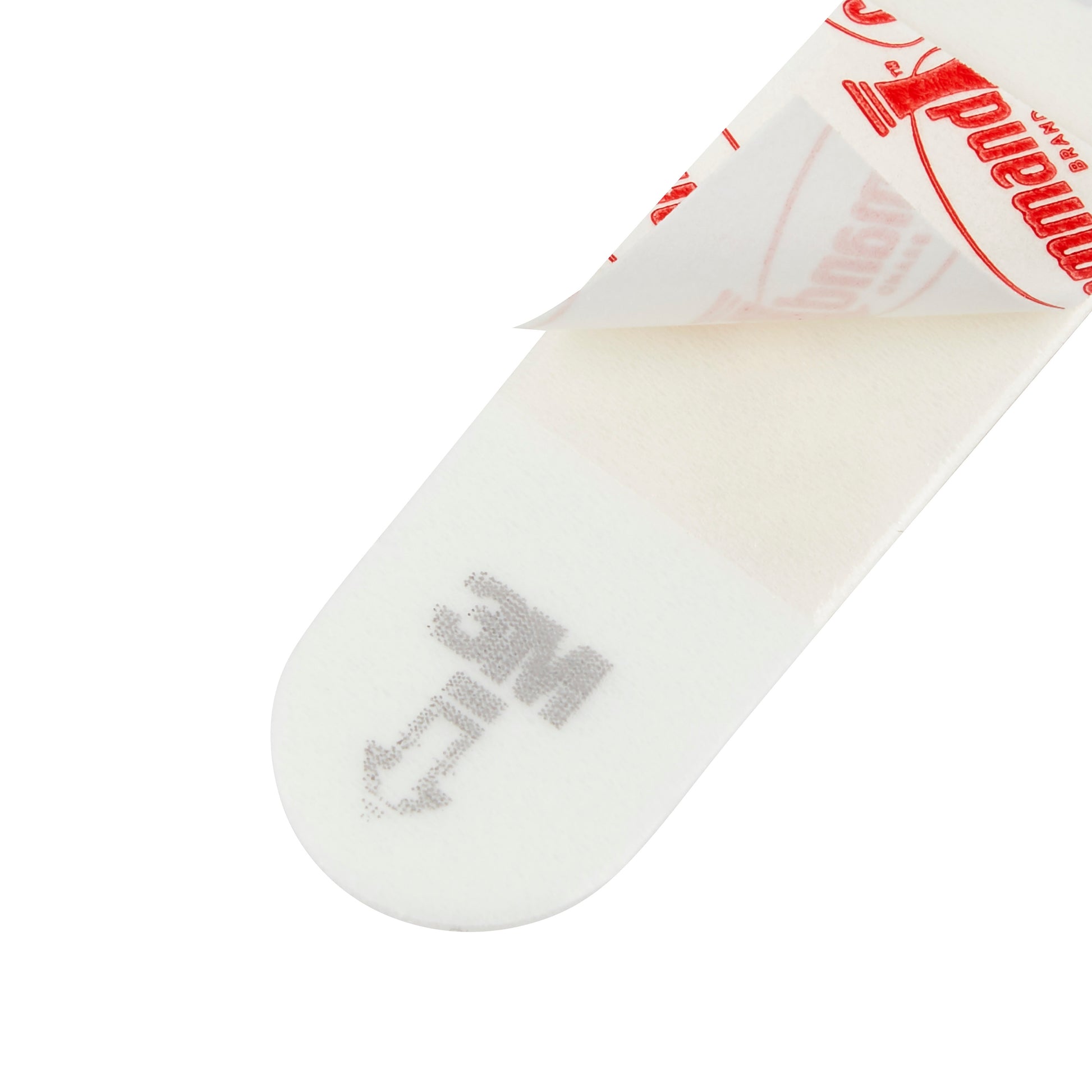 Die Nahaufnahme eines 3M Deutschland GmbH Kleine Command™ Strips S, 17022N (1 Stück) zeigt den weißen Klebestreifen, dessen rot-weiße Umhüllung teilweise abgezogen ist, so dass die klebrige Seite und der Schriftzug "LINE" mit einem Pfeil an einem Ende sichtbar wird.
