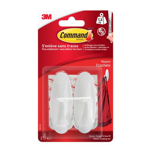 Ein 3M Deutschland GmbH Command™ Medium Designer-Haken, 17081-FGN (1 Stück) verfügt über einen weißen Haken mit Klebestreifen, hält bis zu 1,3 kg, ist leicht zu entfernen und enthält eine mehrsprachige Anleitung.