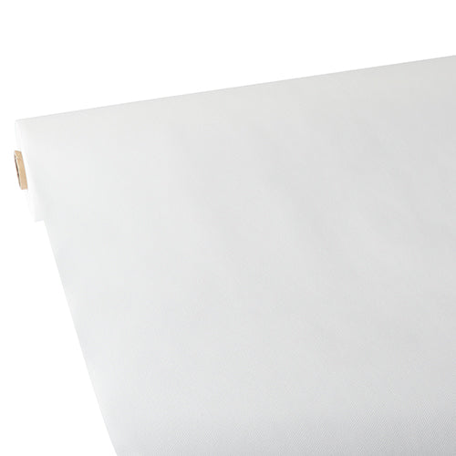 Eine Nahaufnahme einer Rolle Starpak-Tischdecke, stoffähnlich, Vlies „Soft Selection“, teilweise ausgerollt auf einer flachen Oberfläche, wobei der Pappröhrenkern links sichtbar ist.
