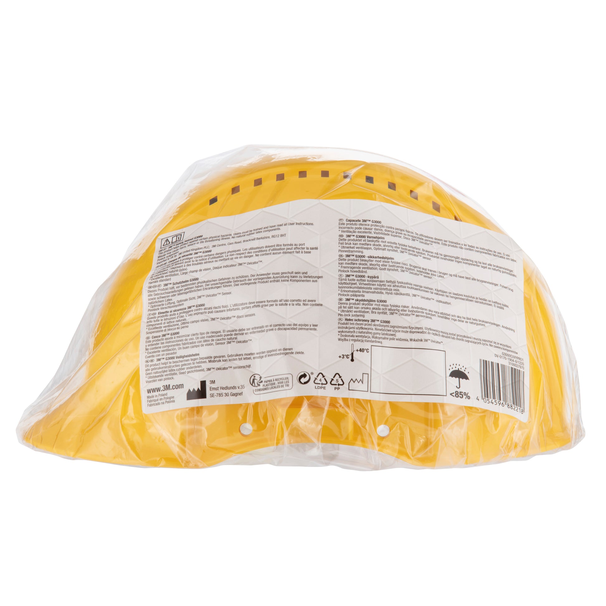 Der gelbe 3M™ Schutzhelm G3000C Uvicator von 3M Deutschland GmbH ist in durchsichtigem Kunststoff versiegelt, mit einem weißen Etikett und schwarzem Text auf der Rückseite, um sicherzustellen, dass er die wichtigsten Sicherheitsstandards erfüllt. Verstellbare Passform über Arretierstift.