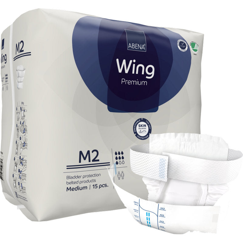 Gezeigt wird ein Paket der Abena Re-Seller GmbH ABENA Wing Premium, das 15 mittelgroße Inkontinenzprodukte mit Gürtel enthält. Vorne ist ein Produkt abgebildet, das den ultimativen Schutz für Erwachsene hervorhebt.