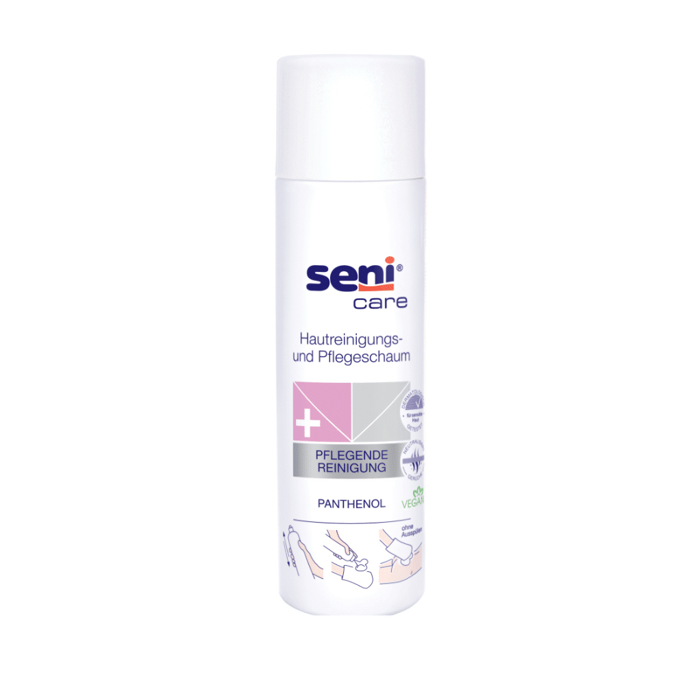 Abgebildet ist eine weiße, zylindrische 500-ml-Flasche Seni Care Hautreinigungs- und Pflegeschaum der TZMO Deutschland GmbH. Das deutsche Etikett mit Anwendungsillustrationen hebt Panthenol und veganfreundliche Inhaltsstoffe für empfindliche Haut hervor. Es verfügt über einen weißen Verschluss.