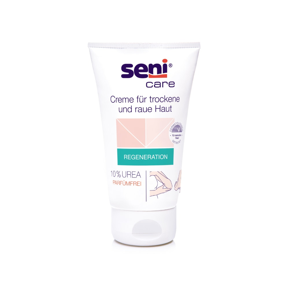 Eine 100-ml-Tube Seni Care Creme von TZMO Deutschland GmbH für trockene und raue Haut hat einen weißen Hintergrund mit hellrosa und grünen Akzenten. Das Etikett weist auf 10 % Urea hin, ist parfümfrei, erhöht den Feuchtigkeitsgehalt und enthält eine deutsche Anleitung.