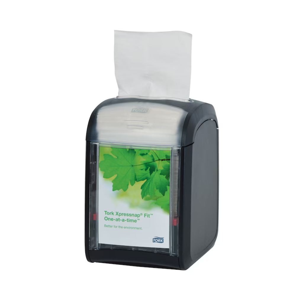 Ein Tork Xpressnap Fit® 272900 Tischspender für Servietten von TORK - Essity Professional Hygiene Germany GmbH verfügt über ein elegantes schwarzes Tischdesign mit einer transparenten Frontplatte mit einem grünen Blattmuster. Im Inneren sind weiße Servietten ordentlich angeordnet, von denen eine zur Verwendung bereitliegt. Dieser Spender verwaltet den Serviettenverbrauch effektiv, indem er jeweils eine Serviette ausgibt.