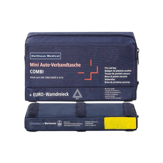 Eine Mini-Verbandtasche COMBI Auto von Holthaus Medical GmbH & Co. KG ist in Blau gehalten und zeigt mehrsprachig beschriftete Inhalte. Dieses Erste-Hilfe-Set enthält eine Warnweste und ein Warndreieck, wobei die gelbe Weste deutlich sichtbar unten zu sehen ist.