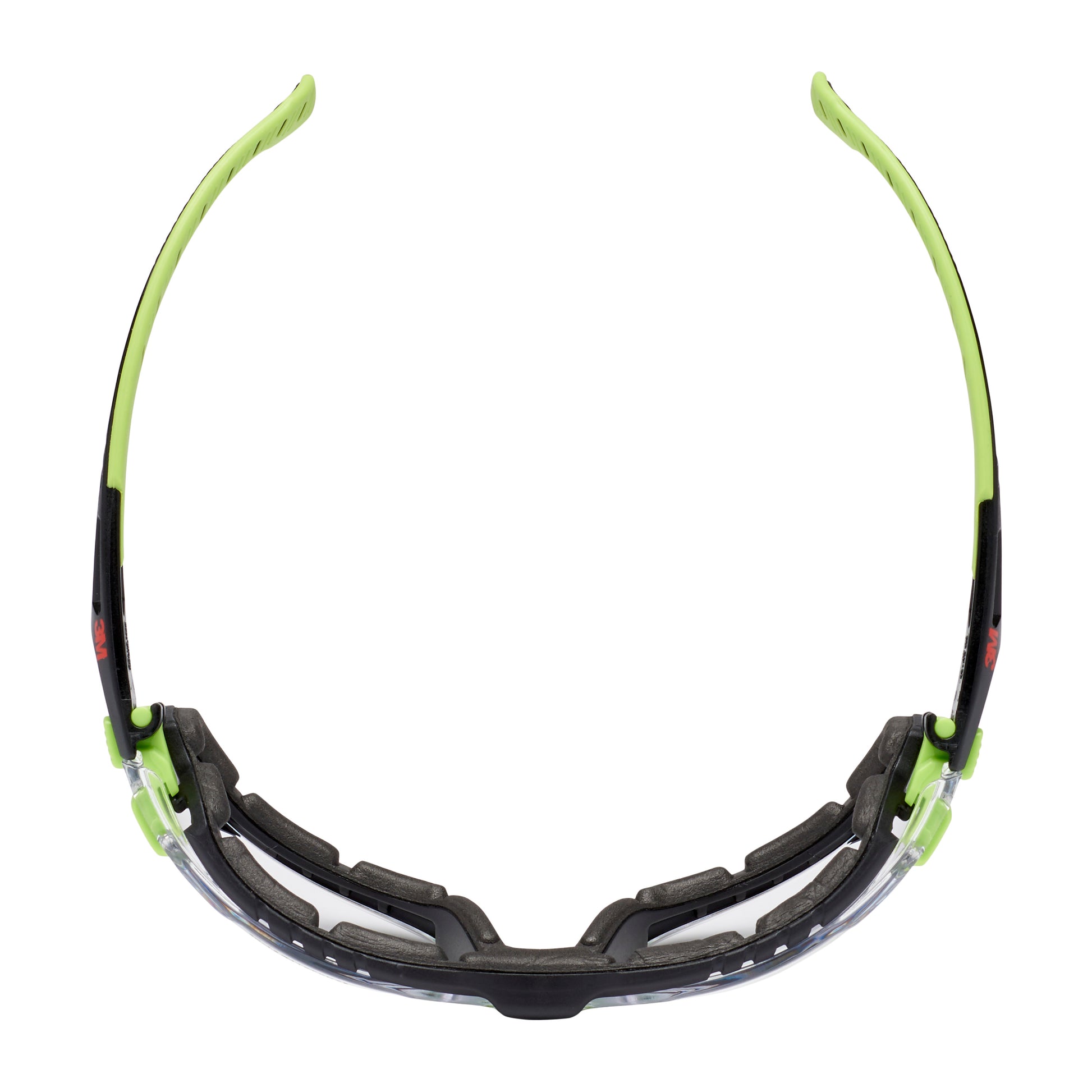 Die 3M™ Solus™ Schutzbrille 1000 von 3M Deutschland GmbH verfügt über eine klare Scheibe, einen schwarzen und neongrünen Rahmen, eine gepolsterte Schaumstoffdichtung und gebogene Bügel. In der Draufsicht hebt die Scotchgard™ beschichtete Schutzbrille ihr Innenfutter hervor.