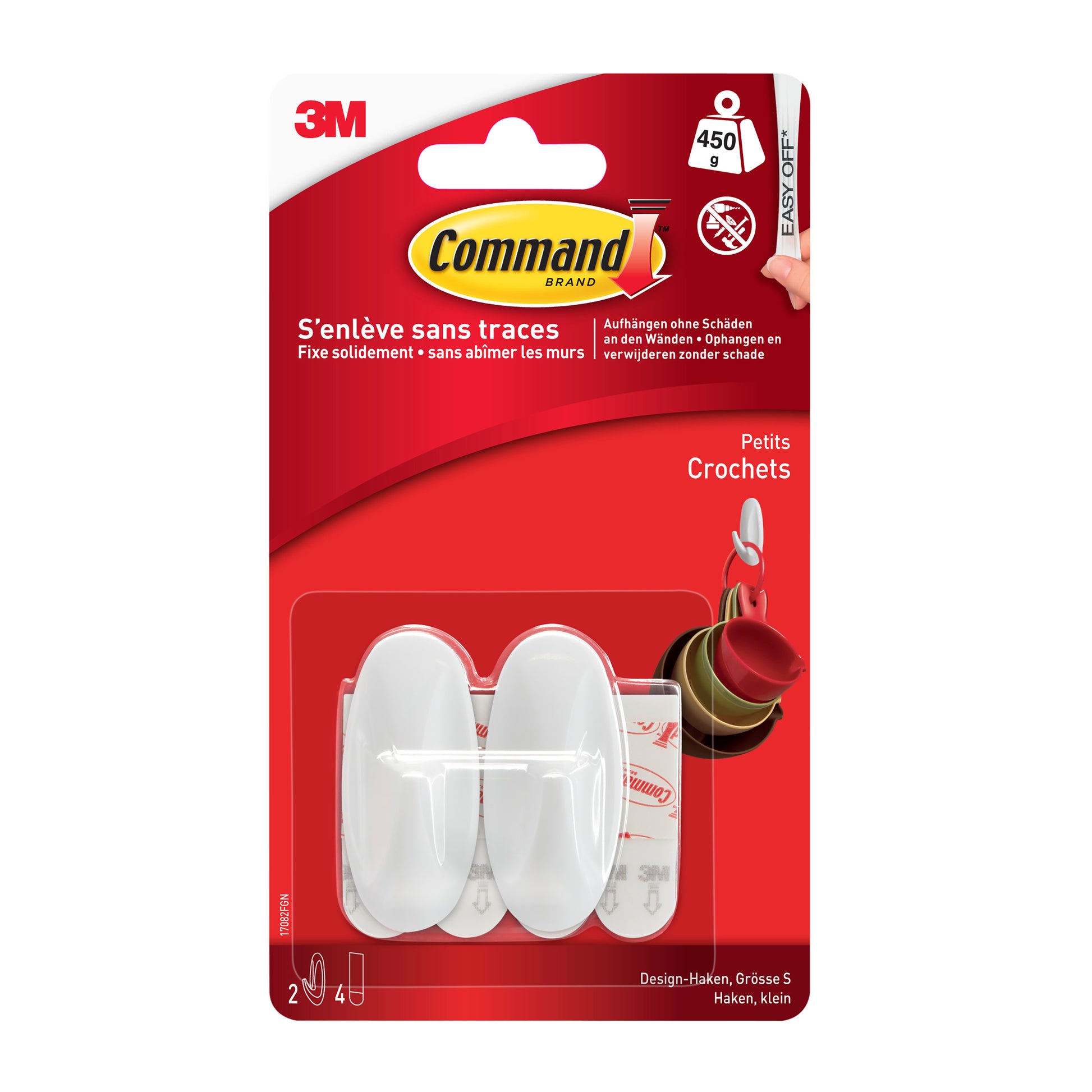 Eine Packung Command™ Small Designer-Haken (1 Stück) von 3M Deutschland GmbH mit einem weißen Haken in einer klaren rot-weißen Verpackung mit französischen Produktinformationen.