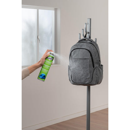 A hand sprays Scotchgard™ Heavy Duty Water Shield, 400ml from 3M Deutschland GmbH onto a gray backpack on the coat rack to provide strong waterproof protection for textiles.