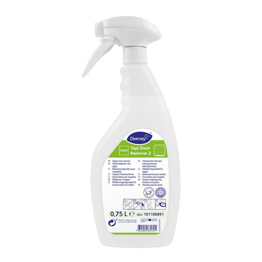Eine weiße 750-ml-Sprühflasche von TASKI Tapi Fleckenentferner 2 (Teppich-Fleckenentferner mit O.N.T. Technologie) von Diversey Deutschland steht aufrecht mit grüner und blauer Grafik auf dem Etikett vor weißem Hintergrund.