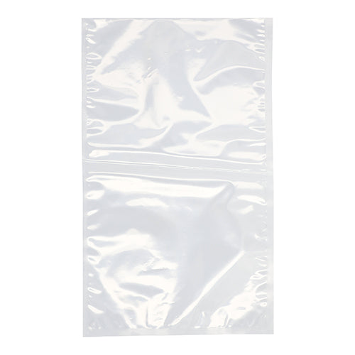 A PAPSTAR 100 edge-sealed bag, PA/PE transparent, from PAPSTAR GmbH, is presented flat and unsealed on a white background. The transparent plastic bag, ideal for food storage, shows slight creases and a central seam.