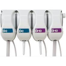 Four white QFM dosing stations from Diversey Deutschland GmbH & Co. OHG are mounted side by side on the wall, each labeled "D2" (blue) or "D10" (purple) and equipped with a nozzle and a hose for precise mixing of cleaning and disinfecting solutions.