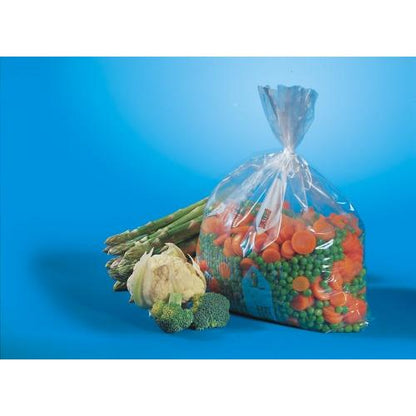 A transparent Starpak 90 freezer bag (LLDPE, 2 l, 30 x 20 cm), filled with frozen mixed vegetables - peas and carrots - lies next to fresh asparagus, cauliflower, and broccoli on a blue surface.
