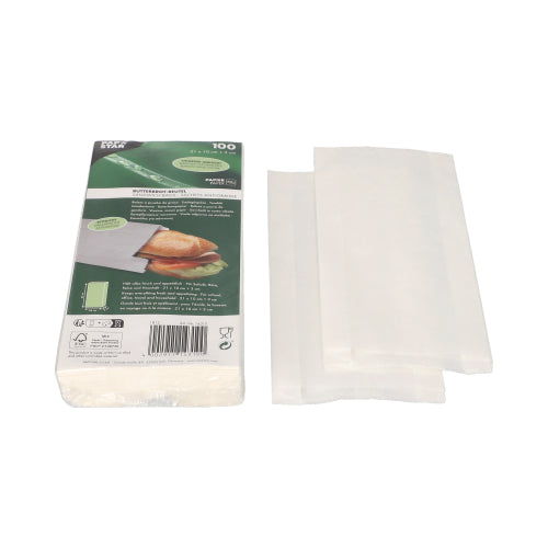 PAPSTAR GmbH bietet 100 weiße, fettdichte Butterbrotbeutel (21x10x3 cm) in Schrumpffolie; Das Verpackungsbild zeigt ein belegtes Sandwich im Beutel und drei einzelne Beutel daneben.