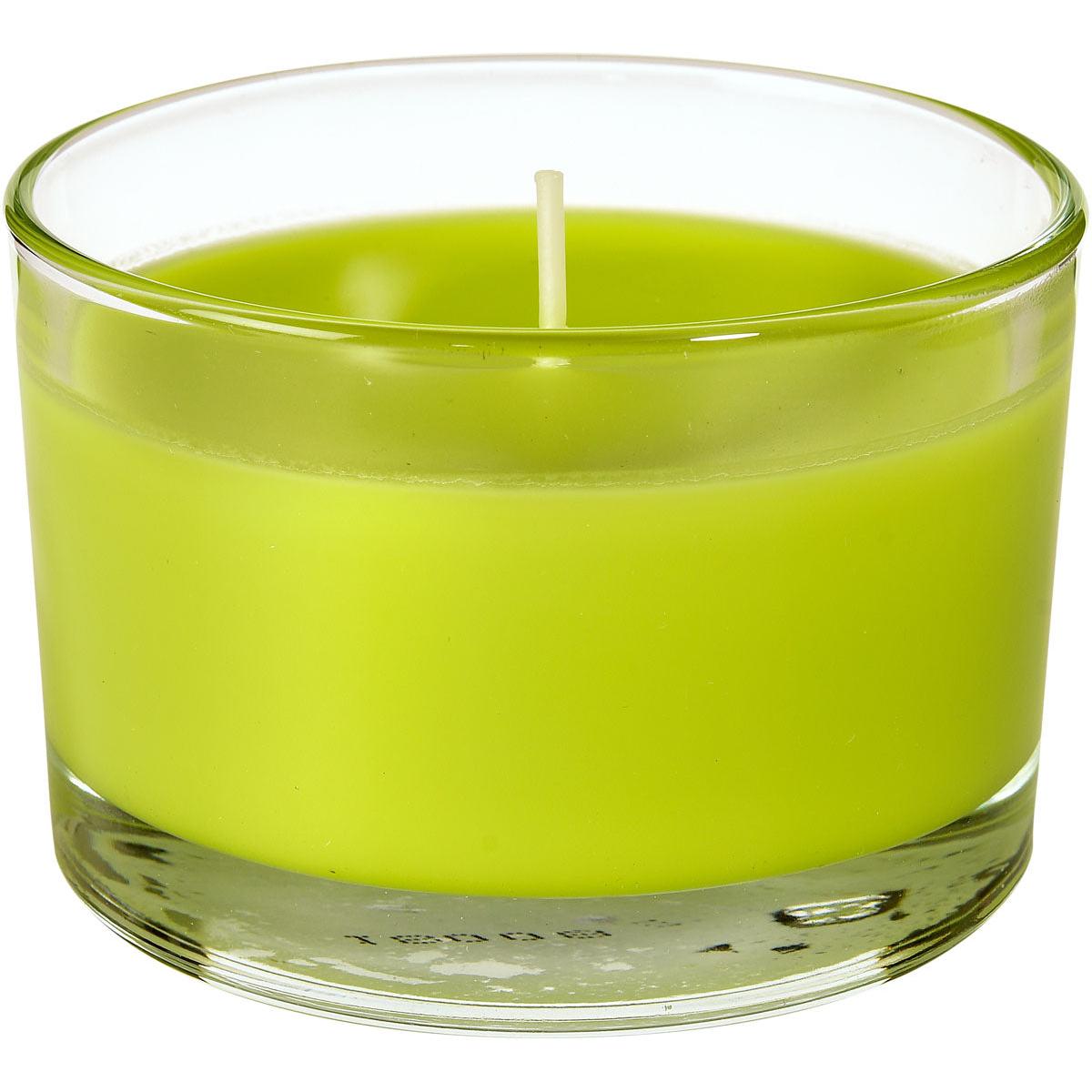 A green candle jar Ibiza (approx. 18h, 58x85mm) by Duni GmbH with a single wick sits unused in a clear glass container - ideal for atmospheric lighting and stylish accents in any room.
