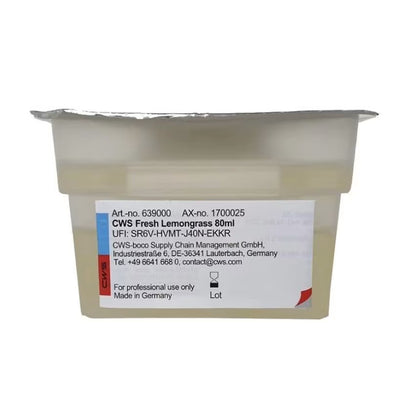 A sealed plastic container labeled "CWS ParadiseLine Washroom Fragrance for Fragrance Dispenser Paradise Air Bar" by CWS, with a foil lid and contact label, intended for professional use of washroom fragrance only.