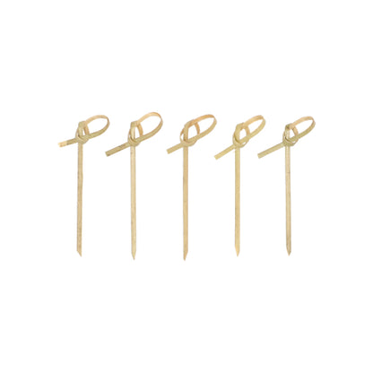 Forty PAPSTAR 40 finger food picks "pure" from PAPSTAR GmbH made of bamboo with pointed ends and looped knots stand neatly and evenly upright on a simple white surface, ideal for serving finger food.