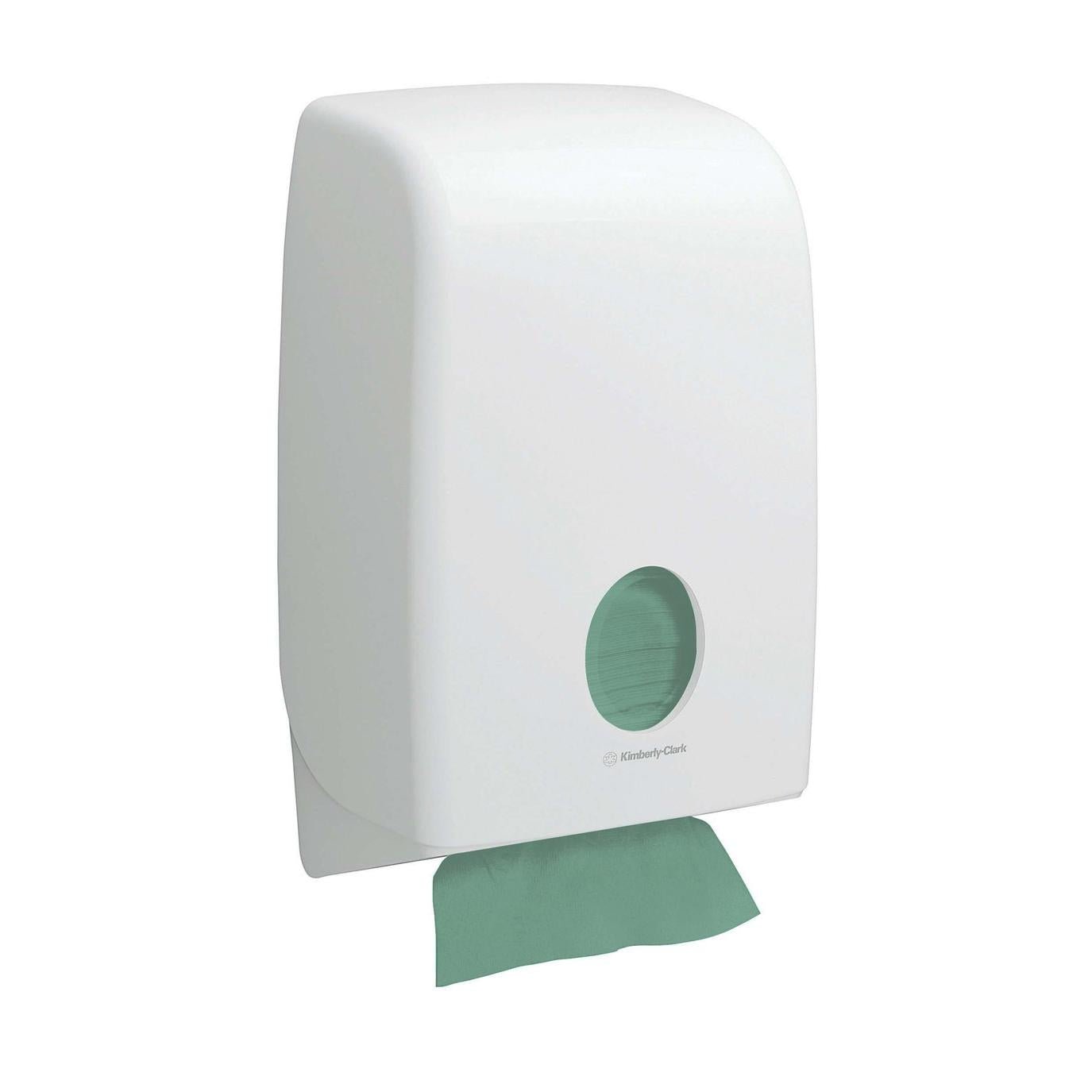 A white wall dispenser with a circular window displays green Kimberly-Clark GmbH Hostess™ NATURA™ zig-zag fold hand towels (23 x 25 cm); an eco-friendly towel is partially dispensed at the bottom.