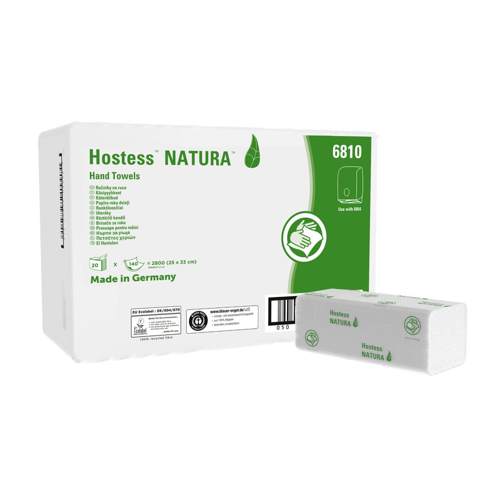 A white box of Hostess™ NATURA™ C-fold towels from Kimberly-Clark GmbH is provided with green text and a leaf logo and contains 20 packs (140 sheets each). Made in Germany, eco-friendly, with product details and application instructions on the box.