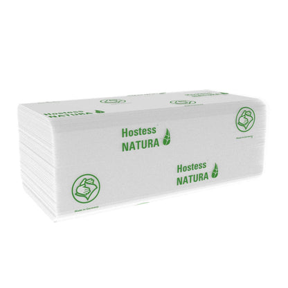 A stack of folded white Hostess™ NATURA™ C-fold towels from Kimberly-Clark GmbH with green leaf graphic, thumbs-up symbol, "Made in Germany" text and eco-friendly branding. 20 x 140 sheets per carton.