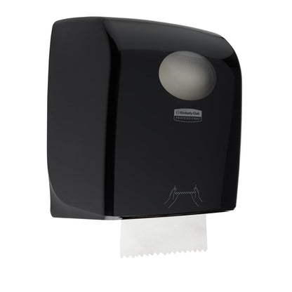 The Aquarius™ roll towel dispenser by Kimberly-Clark GmbH in black (38.20 x 30.90 x 24.00 cm) is a wall-mounted dispenser for hygienic, professional use with paper towel dispensing at the bottom and tear-off instructions on the front.