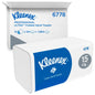 A Kleenex® folded hand towels White/Large-Pack of Kimberly-Clark GmbH stands in front of a branded shipping box, both with 15 clips x 124 sheets per box (15 packs), totaling 1,860 towels.