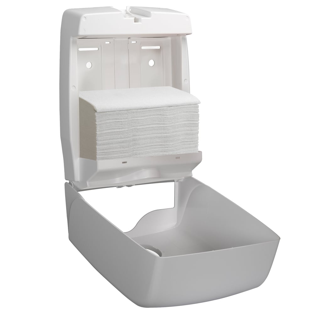 A white wall dispenser is open and shows a stack of Kleenex® folded hand towels - White/Large (15 clips x 124 sheets) by Kimberly-Clark GmbH, neatly arranged in the compartment.