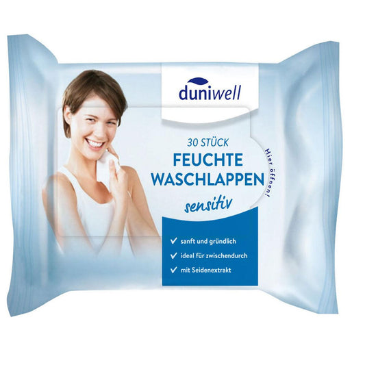 Eine Packung Duni GmbH feuchte Waschlappen, weiß 41035 (30 Stück), zeigt eine lächelnde Frau, die sich die Wange abwischt; auf der Verpackung steht "Reinigung und Pflege", sanftes, gründliches und seidenweiches Viskosegewebe auf Deutsch.