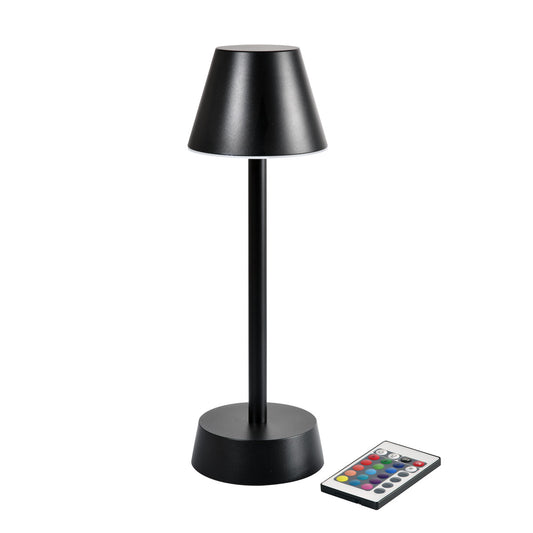 Die Zelda Tischleuchte von Duni GmbH (33 cm x Ø 10,9 cm, graphit 66141) steht neben einer mehrfarbigen Fernbedienung - ideal als modernes Design-Accessoire und perfekt für stilvolle Wohnzimmerdekoration.