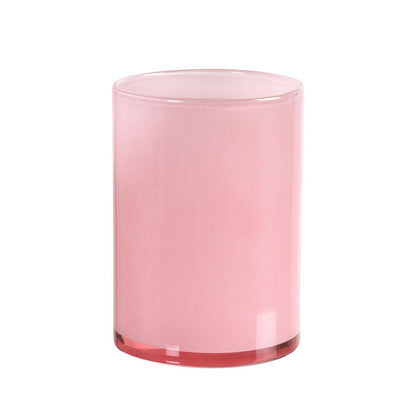 The Silky 115 x 85 mm LED candle holder glass by Duni GmbH is a cylindrical, opaque, pink candle holder with a smooth surface and flat base, standing upright on a white background and providing stylish lighting in any environment.