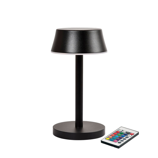 Eine kompakte, moderne schwarze LED-Lampe Nour Midi graphite von Duni GmbH (1 Stück) mit zylindrischem Sockel steht neben einer rechteckigen Fernbedienung mit mehrfarbigen Tasten für eine vielseitige Beleuchtung.
