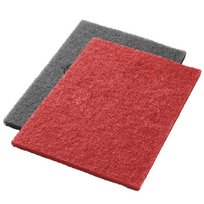 Two rectangular Twister Pads from Diversey Deutschland GmbH & Co. OHG, one of them red, slightly overlap. Their rough texture makes each scrubbing and deep cleaning pad ideal for thorough and efficient cleaning tasks.