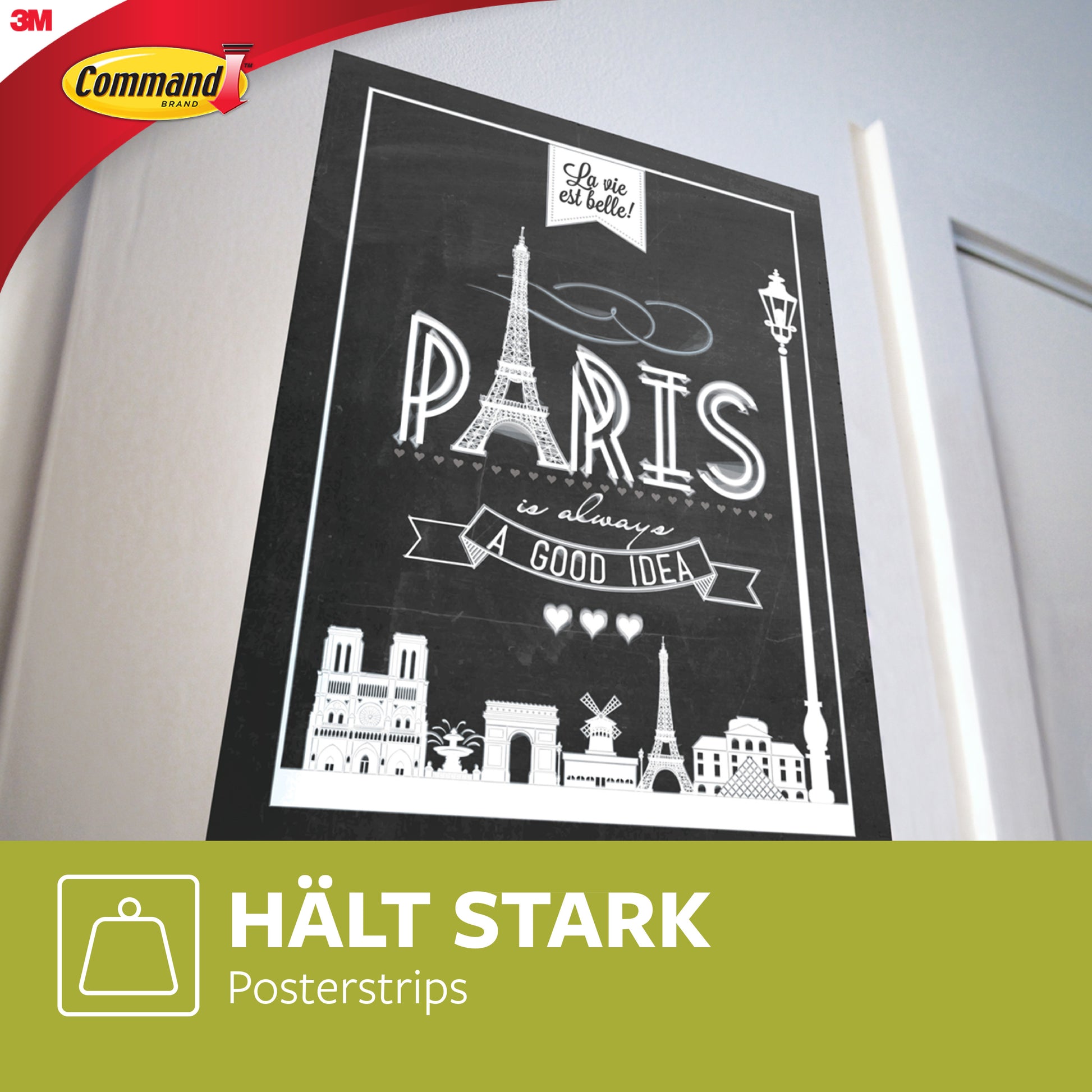 An der Wand hängt ein schwarz-weißes Poster von Pariser Wahrzeichen mit der Aufschrift "Paris ist immer eine gute Idee", gesichert mit Command™ Poster-Strips im Vorteilspack, 17024-VP (1 Stück) von 3M Deutschland GmbH. Auf der Verpackung steht "HÄLT STARK Posterstrips.