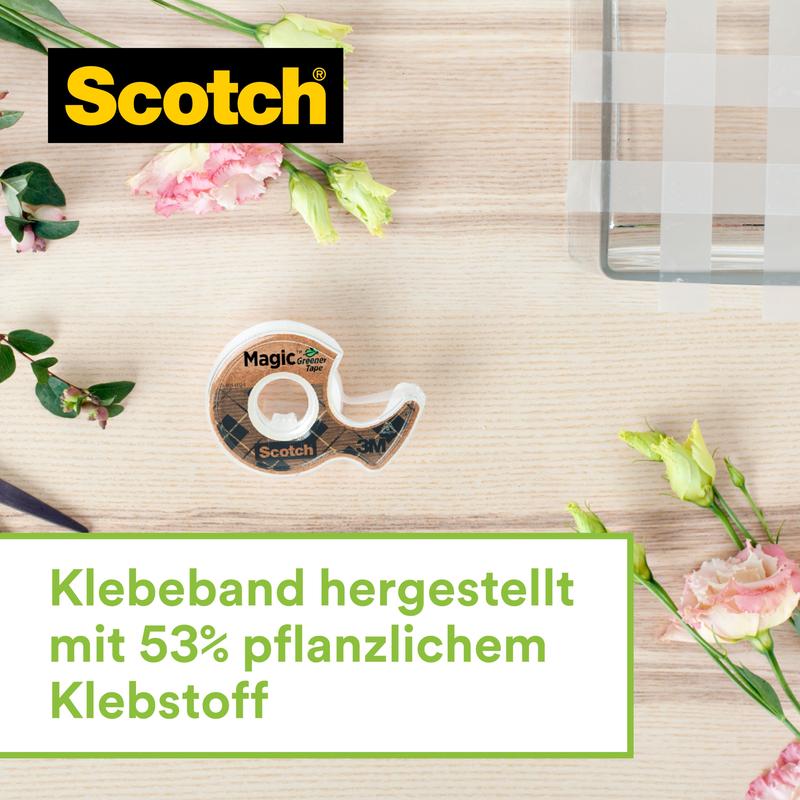 A Scotch™ stainless steel tape dispenser in silver with two rolls of Scotch® Magic™ tape (made from 66% plant-based adhesive, 19 mm x 13.9 m) from 3M Deutschland GmbH stands on light wood next to pink and yellow flowers.