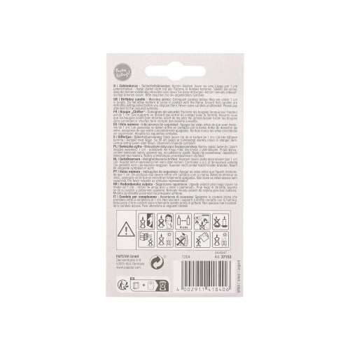 The back of a PAPSTAR GmbH number candle with holder 7 cm "silver" shows safety symbols, instructions, multilingual warnings, a barcode at the bottom, and a hole for hanging the candle on a display hook.