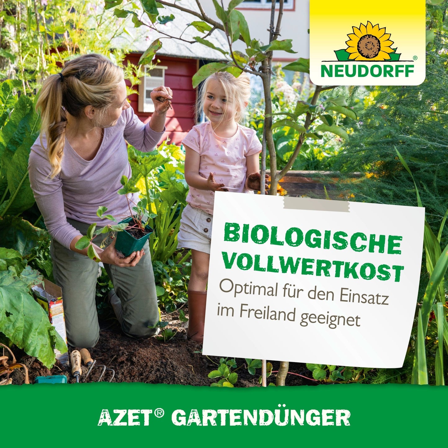 A woman and a young girl garden outdoors among green plants. The woman kneels with a potted plant in hand, while a sign advertises Neudorff Shop Azet Garden Fertilizer as an organic fertilizer for plant care.