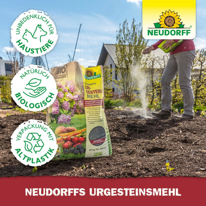 A person sprinkles Neudorff's UrgesteinsMehl from a yellow Neudorff Shop bag onto a garden bed. The image shows symbols for pet-safe, organic, and environmentally friendly packaging. The Neudorff logo appears in the upper right corner.