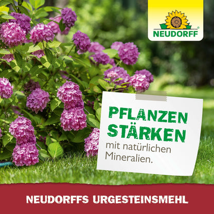 A lush garden with pink hydrangeas. A sign reads: "Strengthen plants with natural minerals." The Neudorff Shop logo is visible at the top right, and a red banner advertises "Neudorff's UrgesteinsMehl" for increasing soil fertility.