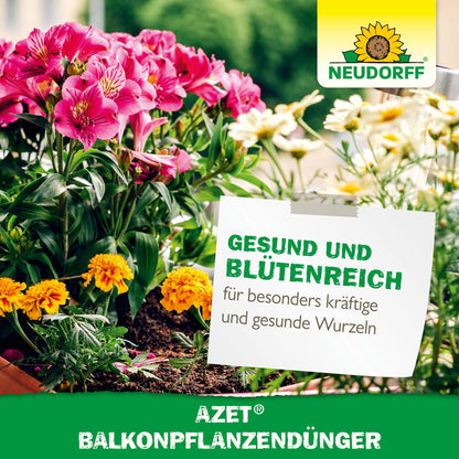 Pink and yellow summer flowers bloom in balcony boxes with a sign: "Healthy and Blooming for particularly strong and healthy roots". The logos of Neudorff Shop Azet Balcony Plant Fertilizer and organic complete fertilizer are visible.