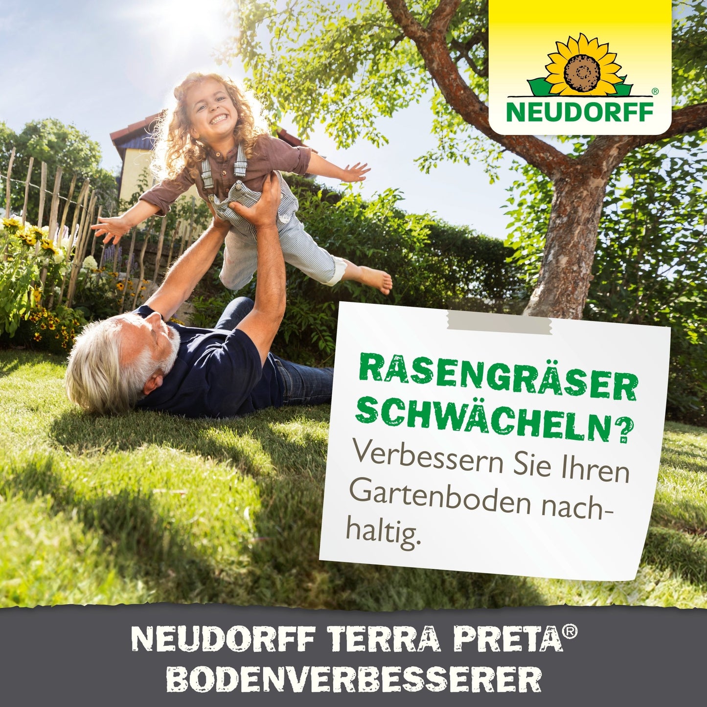 An older man lifts a smiling girl on green grass in a sunny garden. The scene shows how the Neudorff Shop Neudorff Terra Preta Soil Improver enhances the soil and helps you grow healthy fruits and vegetables at home.