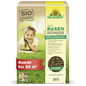 A rectangular box of Neudorff Shop Azet Lawn Fertilizer (2.5-5 kg) shows a photo of a smiling child lying on dense grass. The packaging highlights the organic ingredients and the coverage of up to 50 square meters.
