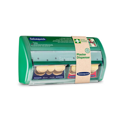 Pictured is a green plastic Salvequick plaster dispenser from Orkla Wound Care AB with two compartments for adhesive bandages. The attached band reads "plaster dispenser" and includes product information. The package contains 1 piece.