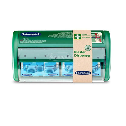 A transparent Salvequick plaster dispenser from Orkla Wound Care AB with visible blue detectable plasters inside, wrapped in a brown paper band with the inscription "Salvequick plaster dispenser, blue detectable | Pack (1 piece)".