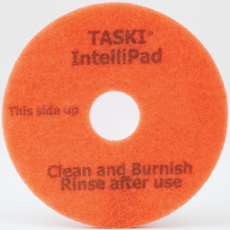 The TASKI Intellipad Combined Cleaning and Polishing Pad for maintenance cleaning from Diversey Deutschland GmbH & Co. OHG is round, orange, and center-punched with the print: "TASKI IntelliPad, This side up, Clean and Polish, Rinse after use.