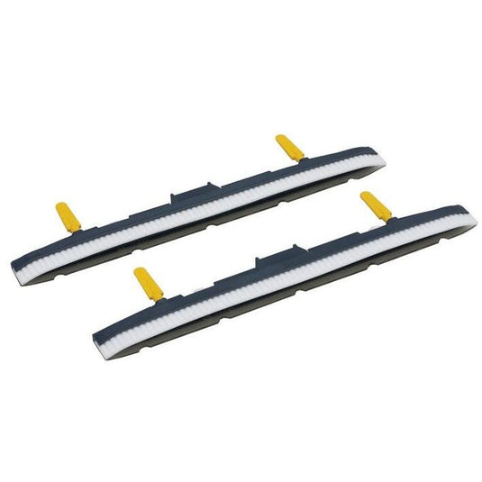 Two suction nozzle bodies with suction vanes for the TASKI swingo 150 by Diversey Deutschland GmbH & Co. OHG, each with white bristles, a dark gray housing, and yellow tabs—ideal for your suction nozzle kit. Pack of 1. Shown on a white background.