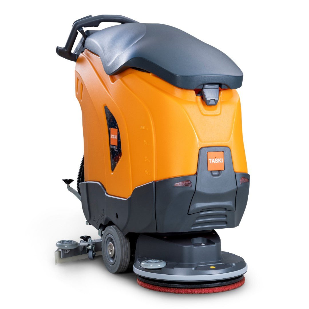 The TASKI ULTIMAXX 1900 SD43 Economy BMS 25A from Diversey Germany is an innovative, non-driven scrubber dryer with an orange-gray housing, 42L tank, handle, wheels, and a visible 43cm single disc on the floor.