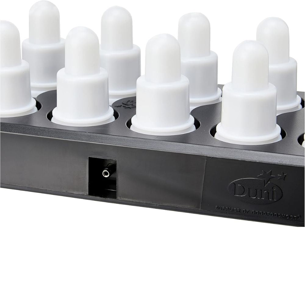 Close-up of a black charging station for the Duni GmbH LED Set, Warm White & Multicolor - 12 Piece Color Changing Lights, with several white cylindrical charging ports with rounded caps and embossed Duni logo next to the socket.