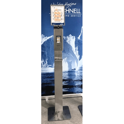 A stainless steel sanitizer dispenser stand with a DR.SCHNELL GmbH & Co. KGaA Dr. Schnell drip tray for dispensers and a digital instruction screen stands in front of icebergs and sea, creating a clear, modern atmosphere.