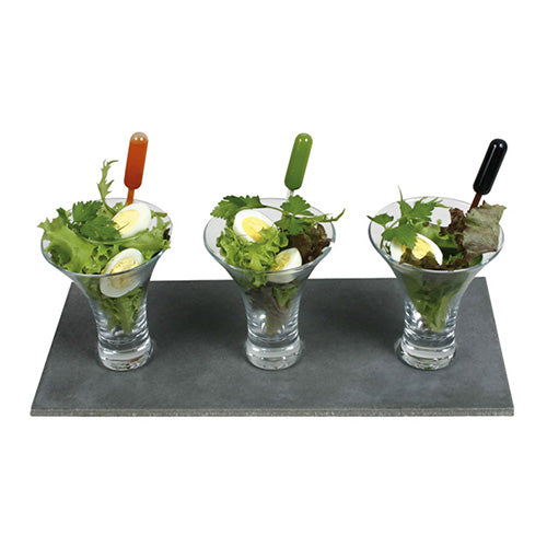Three martini glasses with leafy greens and boiled eggs are each equipped with a Starpak 100 Pipette, PE transparent from Starpak for precise dosing of the dressing. All glasses are neatly arranged on a rectangular slate plate.